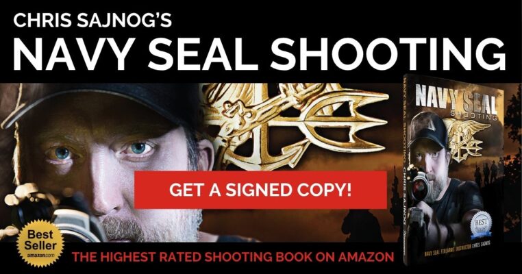 Image of Chris Sajnog with a copy of his bestselling firearms training manual - Navy SEAL Shooting